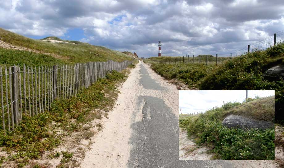 wandelweg met op de zijkant van de weg een wand van een bunker